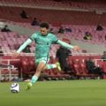 Trent Alexander-Arnold crosses the ball against Arsenal
